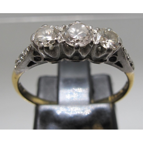 377 - 18ct gold platinum mounted three stone diamond ring with diamond set shoulders.  Ring size M&1/2.  A... 