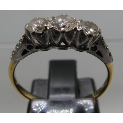 377 - 18ct gold platinum mounted three stone diamond ring with diamond set shoulders.  Ring size M&1/2.  A... 