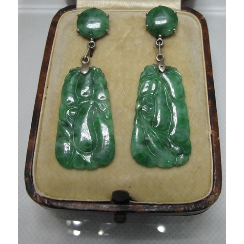 381 - A pair of jade Art Deco earrings set in silver with screw back fittings.  Length of drop 5cm.  
(B.P... 