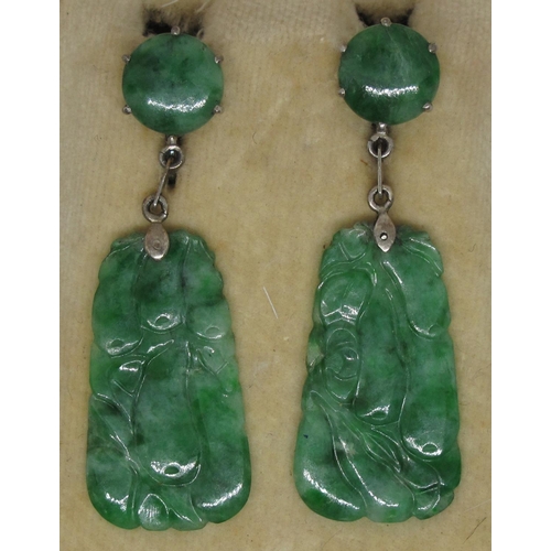 381 - A pair of jade Art Deco earrings set in silver with screw back fittings.  Length of drop 5cm.  
(B.P... 