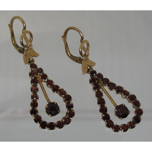 382 - A pair of 18ct gold and garnet drop earrings.  Length of drop 4cm.  Approx weight 8.1 grams.
(B.P. 2... 