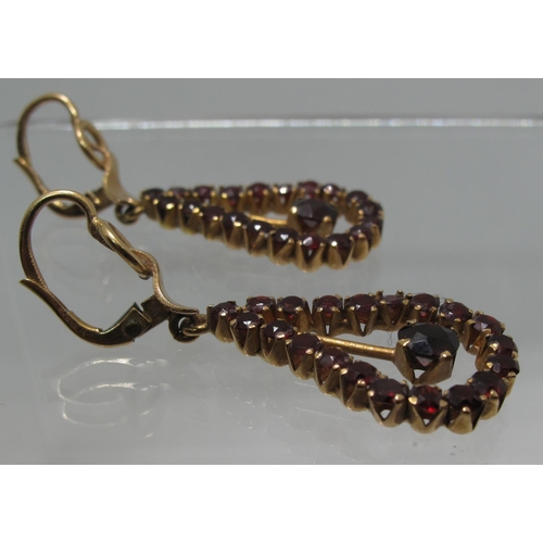 382 - A pair of 18ct gold and garnet drop earrings.  Length of drop 4cm.  Approx weight 8.1 grams.
(B.P. 2... 