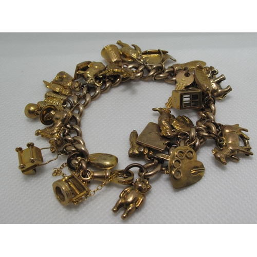 383 - A 9ct gold charm bracelet with various 9ct gold and yellow metal charms including a sailing ship, pr... 