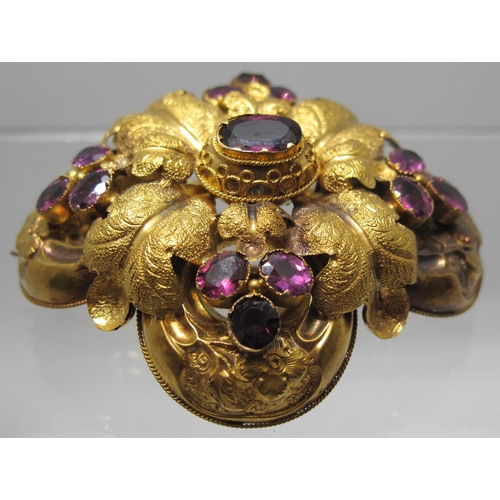 384 - A Victorian bloomed gold brooch engraved with flowers and foliage and set with foiled amethysts. 5.5... 