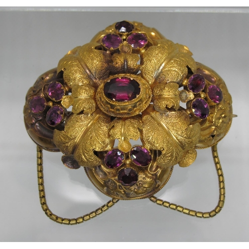 384 - A Victorian bloomed gold brooch engraved with flowers and foliage and set with foiled amethysts. 5.5... 