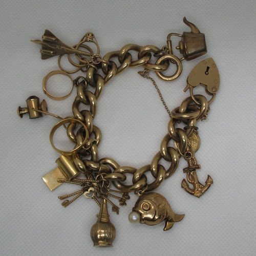 390 - A 9ct gold curb link charm bracelet with various charms including, concorde, a fish, 22ct gold weddi... 