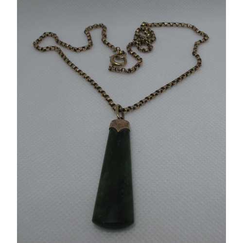 393 - A Jade Art Deco pendant set in 9ct gold on a 9ct gold chain.  Approx weight 14.6 grams.
(B.P. 21% + ... 