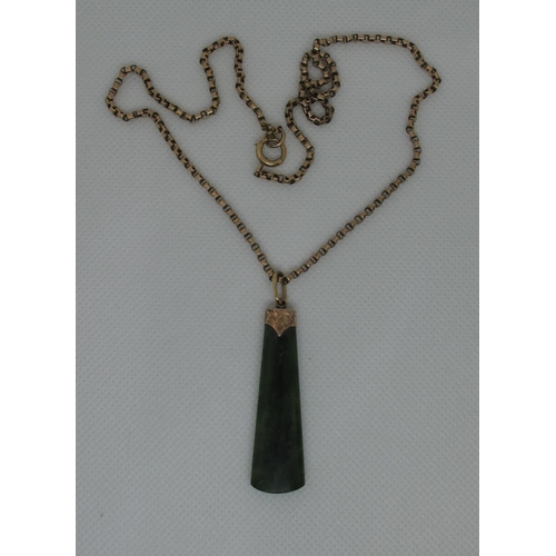 393 - A Jade Art Deco pendant set in 9ct gold on a 9ct gold chain.  Approx weight 14.6 grams.
(B.P. 21% + ... 