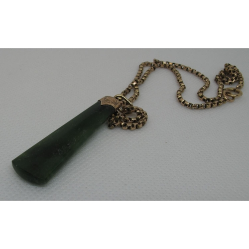 393 - A Jade Art Deco pendant set in 9ct gold on a 9ct gold chain.  Approx weight 14.6 grams.
(B.P. 21% + ... 