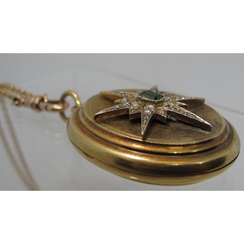 397 - A Victorian oval locket set to the front with an emerald and diamond starburst.  Approx weight 26.5 ... 