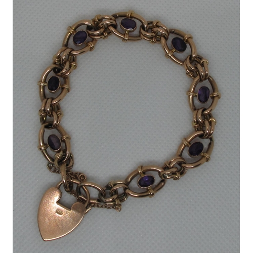 399 - A Victorian charm bracelet set with amethysts and having a heart shaped padlock clasp.  Approc weigh... 