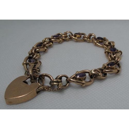 399 - A Victorian charm bracelet set with amethysts and having a heart shaped padlock clasp.  Approc weigh... 