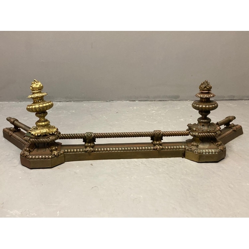 434 - 19th Century Rococo style yellow metal fire fender with two urn shaped capitals and rope twist bars.... 