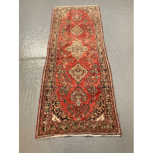 438 - Persian Hamadan red wash ground runner with multicoloured stylised flowers and foliage.  290x100cm a... 