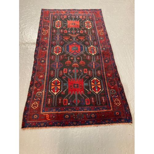 447 - Rich navy and red ground Kurdish rug with unique medallion designs. 228x122cm approx.   (B.P. 21% + ... 