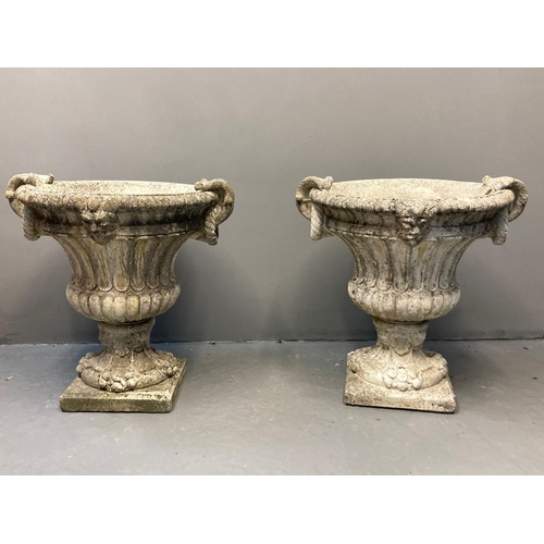 454 - Pair of 19th century style composition Campana urn shaped planters, having moulded mask head and rop... 