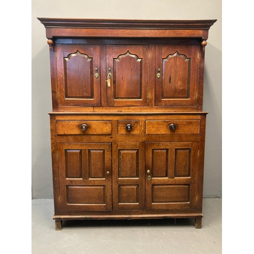 67 - Early 19th Century Welsh oak Deuddarn, the moulded cornice flanked by carved baluster finials above ... 