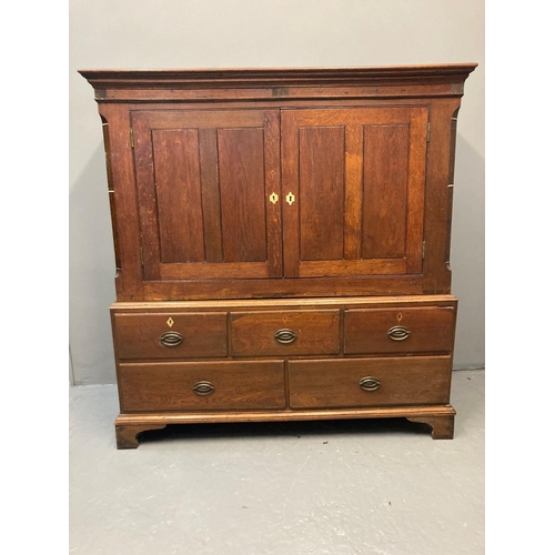 74 - Early 19th Century Welsh oak low two stage press cupboard, the moulded top above two blind panelled ... 