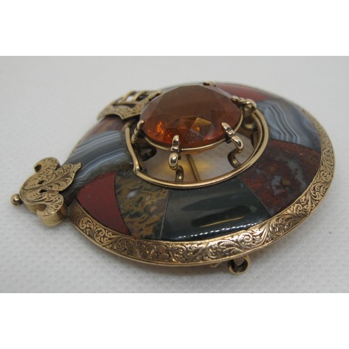 388 - A Victorian Scottish pebble brooch set in yellow metal with agate stones and to the centre with a ca... 