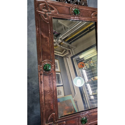 79A - Made for Liberty & Co, London, an Arts & Crafts copper framed mirror, overall decorated with four gr... 