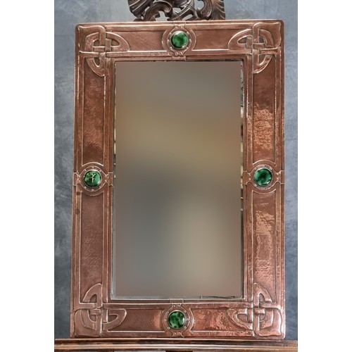 79A - Made for Liberty & Co, London, an Arts & Crafts copper framed mirror, overall decorated with four gr...
