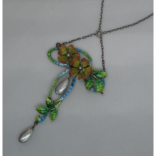 405 - An Art Nouveau silver and enamel pendant modelled as two pearl set flowers amongst foliage with moth... 