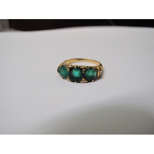 316 - A three stone emerald ring set in yellow metal.  Ring size M & 1/2.  Approx weight 4.8 grams.
(B.P. ... 