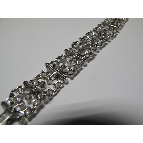 321 - Diamond openwork bracelet of hinged square links with hinged integral clasp.  Set in unmarked white ... 