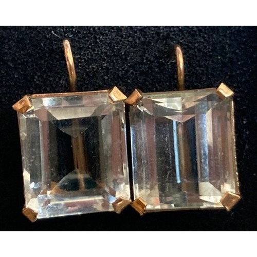 386 - A pair of step cut pale blue stone earrings set in yellow metal. (tests as 9ct gold)  Approx weight ... 