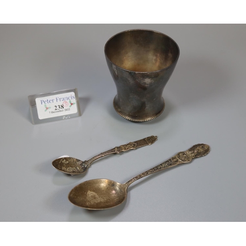 238 - Two silver commemorative spoons, one marked 'Here We Rest', together with a white metal beaker.  (B.... 