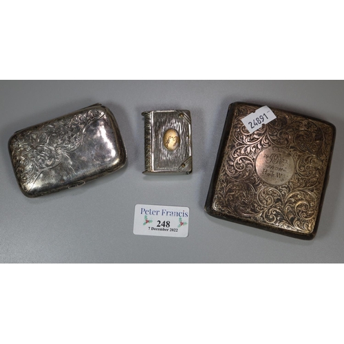 248 - Two silver foliate chased cigarette cases.  5.1 troy ozs.  together with novelty white metal vesta c... 