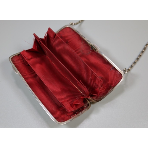 249 - Edwardian silver foliate chased ladies purse with silver plated chain.  (B.P. 21% + VAT)