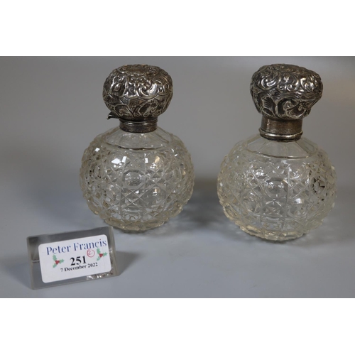 251 - Two similar globular hobnail cut glass scent bottles with silver tops.  (2)  (B.P. 21% + VAT)