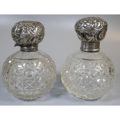 251 - Two similar globular hobnail cut glass scent bottles with silver tops.  (2)  (B.P. 21% + VAT)