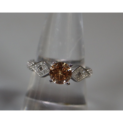 349 - Padparadscha and white topaz silver dress ring. 3.5g approx. Ring size O.
(B.P. 21% + VAT)