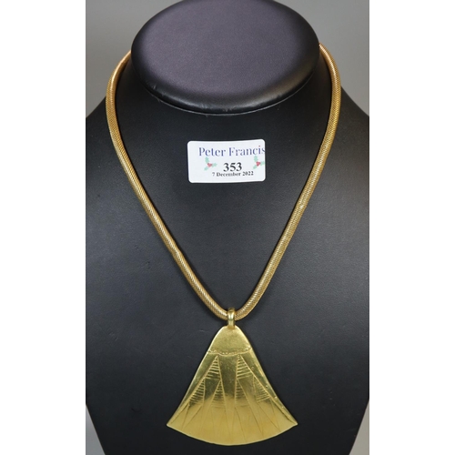 353 - Archaic design triangular yellow metal pendant, marked 18K on an 18ct gold snake chain. Total weight...