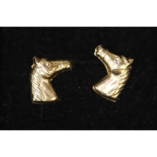 357 - Pair of gold horses head stud earrings.
(B.P. 21% + VAT)