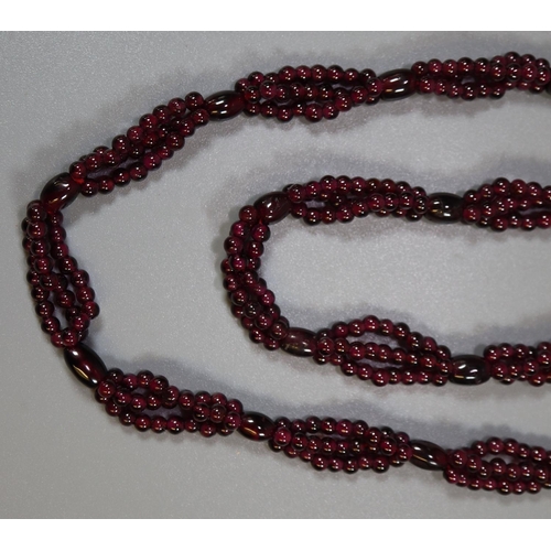 377 - Garnet bead triple strand necklace. 
(B.P. 21% + VAT)