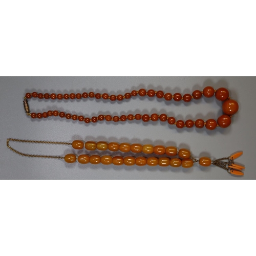 381 - Two strings of amber type beads. 
(B.P. 21% + VAT)