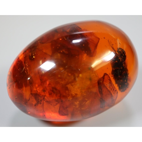 385 - Amber and plastic egg.
(B.P. 21% + VAT)