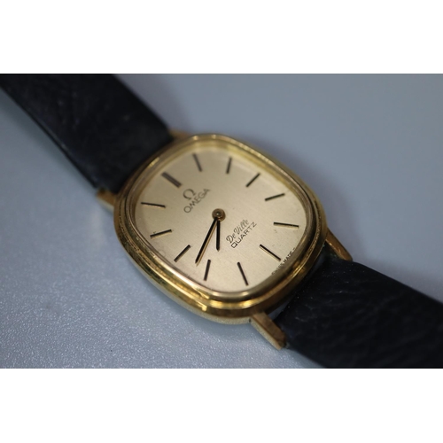 399 - Omega gold plated lady's oval faced Deville quartz wristwatch with leather strap. Lacks crown. Boxed... 