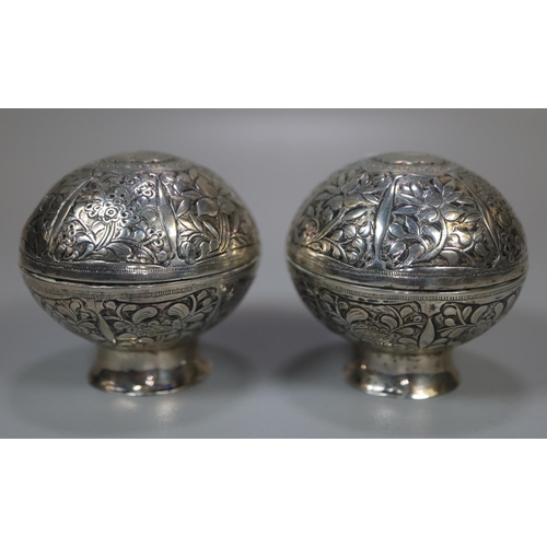 436 - Pair of Indian silver foliate decorated globular lidded salts on pedestal bases.  (2)  3.4 troy ozs ... 