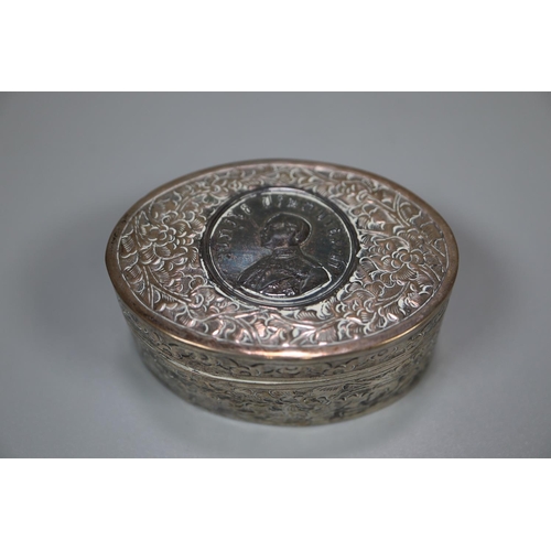 442 - Asian silver oval engraved and repousse decorated box and cover with portrait coin inset.  (B.P. 21%... 