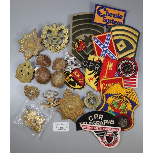 446 - Bag of Commonwealth cap badges and embroidered badges to include: Ontario Northland Railway, Flint &... 