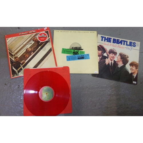 563 - Three vinyl LPs of The Beatles to include; 1962-66 double album on red vinyl, 'The Beatles at the Ho... 