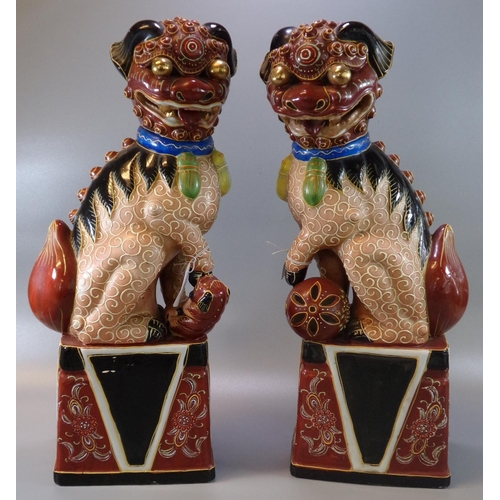 63 - Pair of Chinese porcelain polychrome Temple lions or Fo Dogs.  45cm high approx.  20th century.  (2)... 