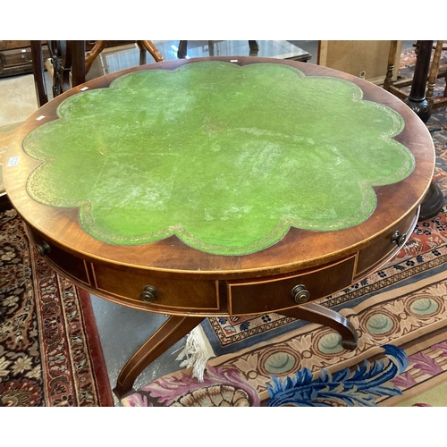 677 - Mahogany inlaid revolving drum table having shaped leather inset top above an arrangement of drawers... 