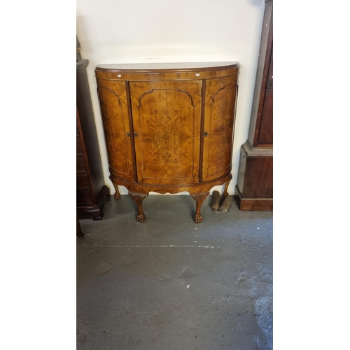 692 - Early 20th century walnut bow front cabinet having three drawers and standing paw feet.  (B.P. 21% +... 