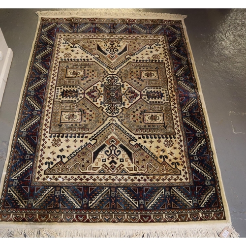 709 - Small middle eastern design cream and blue ground carpet, having geometric floral and foliate design... 