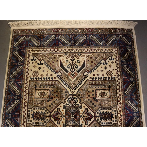 709 - Small middle eastern design cream and blue ground carpet, having geometric floral and foliate design... 